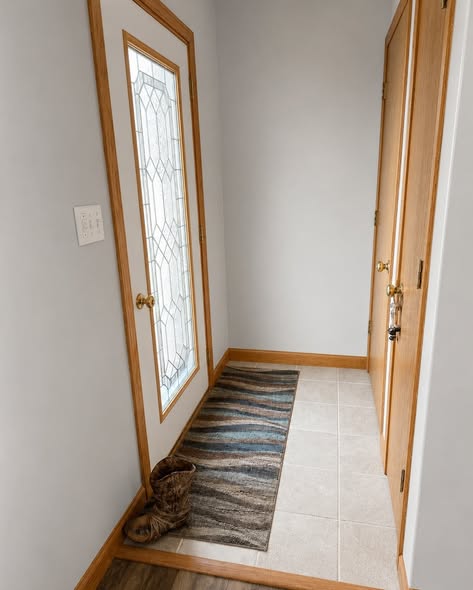Entryway after with light gray walls and natural wood trim